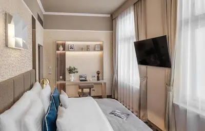 a hotel room with a bed and a television at Maestro by Adrez in Prague