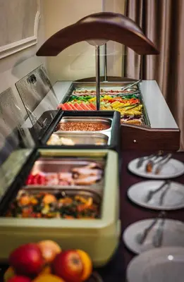 a buffet line with many different types of food at Maestro by Adrez in Prague