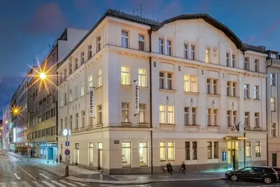 a large white building on a city street at night at Maestro by Adrez in Prague