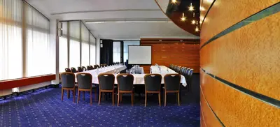 a conference room with a long table and chairs at Hotel Olympik in Prague