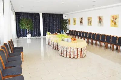 a row of tables in a room with chairs at Hotel Olympik in Prague