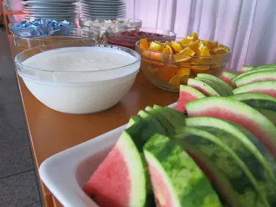 a table topped with a plate of watermelon and other foods at Olympik Tristar in Prague