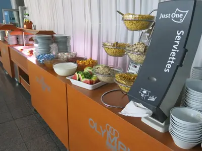 a buffet line with plates and bowls of food at Olympik Tristar in Prague