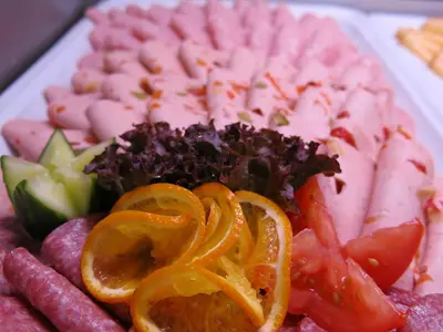 a plate of food with oranges and other vegetables at Olympik Tristar in Prague