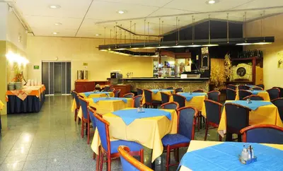 a restaurant with blue and yellow tables and chairs at Olympik Tristar in Prague