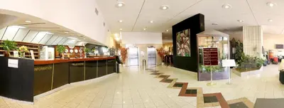 a mall with a bar in the middle of a building at Olympik Tristar in Prague