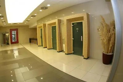 a hallway with a row of doors in a building at Olympik Artemis in Prague