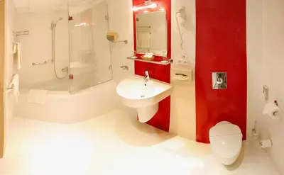 a bathroom with a sink and a toilet and a shower at Olympik Artemis in Prague