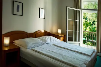 a bedroom with a bed and a window with a view at Vila Josefina in Prague