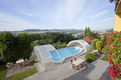 a backyard with a swimming pool and a gazebo at Pension PRIMUS in Beroun