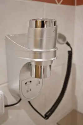 a silver coffee pot hanging on a wall at Pension PRIMUS in Beroun