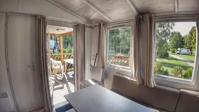 a room with chairs and a balcony with windows at Camping Sokol Praha in Prague