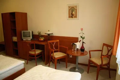 a room with a desk with a computer and chairs at Alexis in Prague