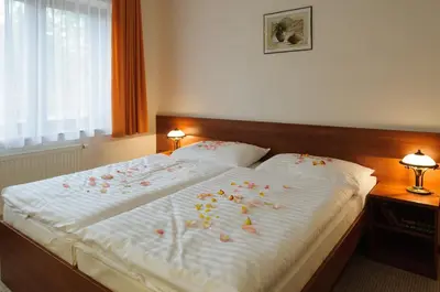 a bed with flowers on it in a bedroom at Alexis in Prague