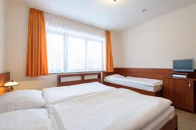a hotel room with two beds and a window at Alexis in Prague