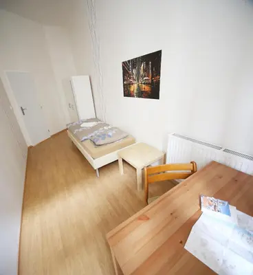 a small room with a table and a bed in it at Vltava Apartments Prague 7 in Prague