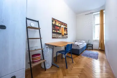 a small room with a table and a bed at Vltava Apartments Prague 7 in Prague