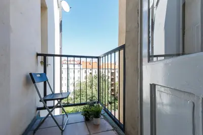 a blue chair sitting on a balcony with a view at Slavikova Residence in Prague