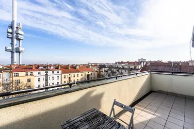 a bench on a balcony with a view of a city at Slavikova Residence in Prague