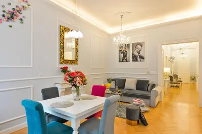 a living room with a table and chairs at Vogue apartment near by Wenceslas Square in Prague