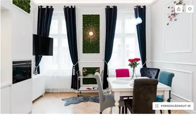 a living room with a table and a dining room at Vogue apartment near by Wenceslas Square in Prague
