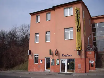 a building with a sign on the side of it at Pension Dobroucky in Prague