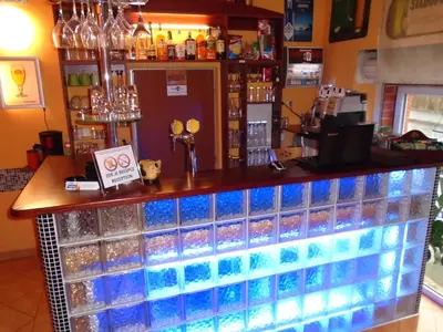 a bar with blue glass tiles on the counter at Pension Dobroucky in Prague
