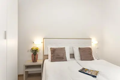 a bedroom with a bed with white sheets and pillows at Prague City Residence in Prague