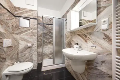 a bathroom with a sink and a toilet and a shower at Prague City Residence in Prague