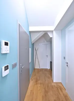 a hallway with blue walls and a white ceiling at Designer Loft 2 in Prague