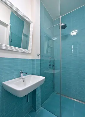 a bathroom with a sink and a glass shower at Designer Loft 2 in Prague