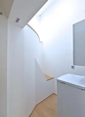 a white bathroom with a sink and a mirror at Designer Loft 2 in Prague