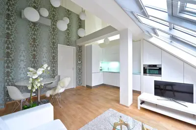 a living room with a couch and a tv at Designer Loft 2 in Prague