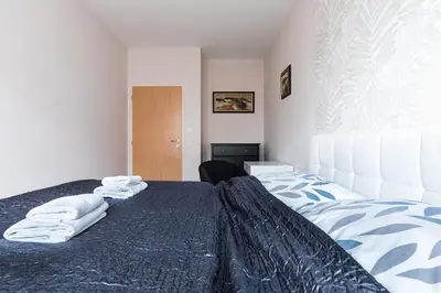 a bedroom with a bed with towels on it at The SUNNY PRAGUE APPARTMENT&Garage in Prague