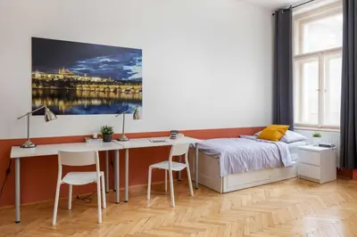 a bedroom with a desk and a bed and a desk at Letná Apartments in Prague