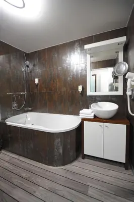 a bathroom with a tub and a sink and a mirror at Caramell in Louny