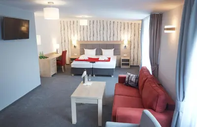 a hotel room with a bed and a couch at Penzion Archery in Nová Ves