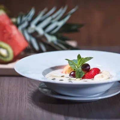 a bowl of food with fruit on a table at Penzion Archery in Nová Ves