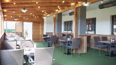 a restaurant with tables and chairs in a room at Penzion Archery in Nová Ves