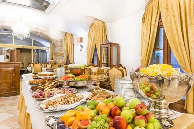 a buffet of fruits and vegetables on a table at Charles Bridge Palace in Prague