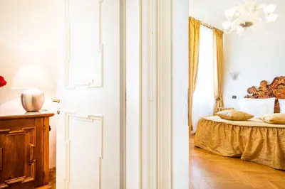 a bedroom with a bed and a window at Charles Bridge Palace in Prague