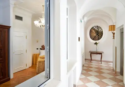 a hallway with a table and a mirror at Charles Bridge Palace in Prague