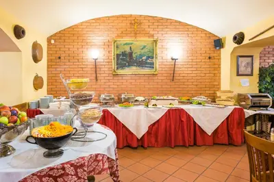 a room with a table with food on it at La Fenice in Prague