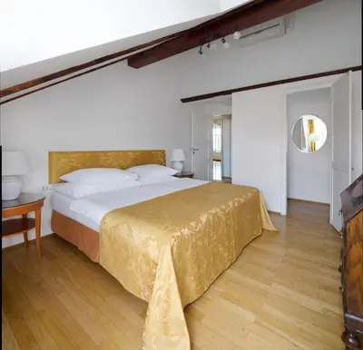 a bedroom with a large bed and a table at La Fenice in Prague