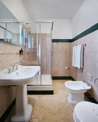 a bathroom with a sink and a toilet and a shower at La Fenice in Prague