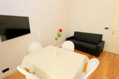 a white table with a vase with a flower on it at Luxury apartments Krocínova in Prague