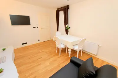 a living room with a couch and a table at Luxury apartments Krocínova in Prague