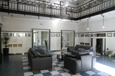 a living room with two leather chairs and a table at Art Deco Hotel Hoffmann in Kladno