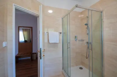 a bathroom with a shower with a glass shower stall at Art Deco Hotel Hoffmann in Kladno