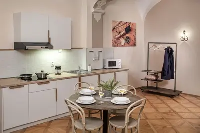 a kitchen and dining room with a table and chairs at 6 Continents Apartments by Adrez in Prague